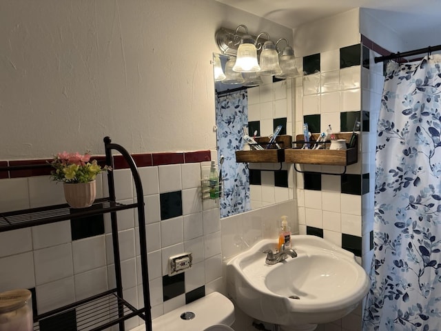 4221 N Sawyer Ave, Chicago, IL 60618 - bathroom featuring curtained shower, a sink, wainscoting, and tile walls