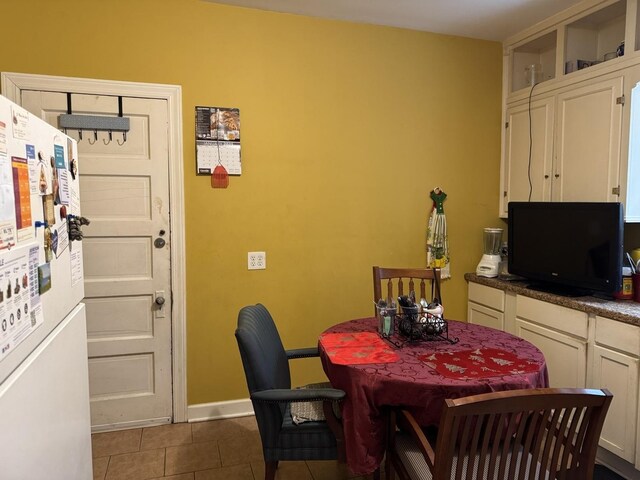 4221 N Sawyer Ave, Chicago, IL 60618 - dining room with dark tile patterned floors and baseboards