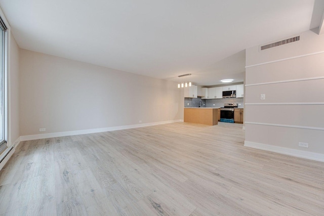 unfurnished living room with baseboards, light wood finished floors, and visible vents