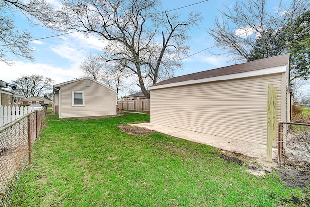 view of yard with a fenced backyard and an outbuilding