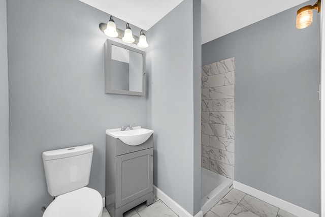 full bathroom featuring baseboards, toilet, vanity, marble finish floor, and a stall shower