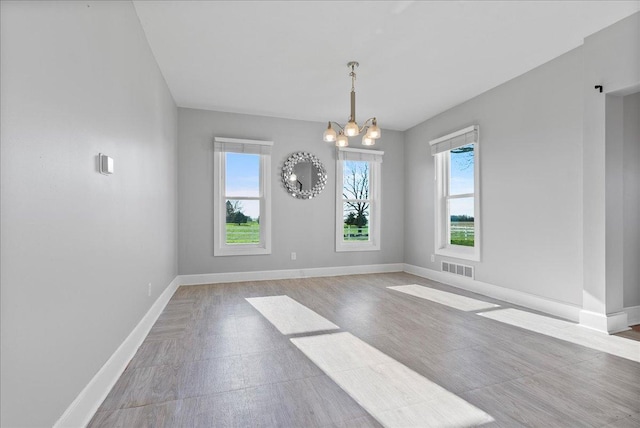 103 E 1400 N Rd, Danvers, IL 61732 - unfurnished dining area featuring a chandelier and baseboards