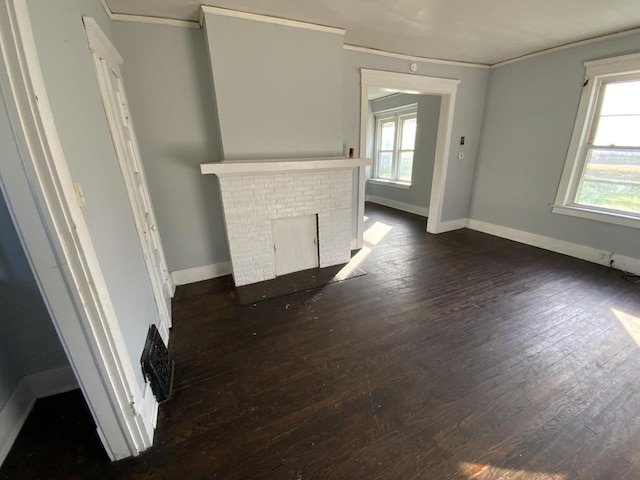 405 Chandler St, Danville, IL 61832 - unfurnished living room with plenty of natural light, crown molding, and dark wood finished floors