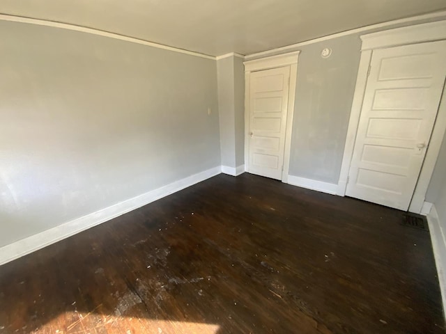 405 Chandler St, Danville, IL 61832 - unfurnished bedroom featuring baseboards, dark wood-style floors, and a closet