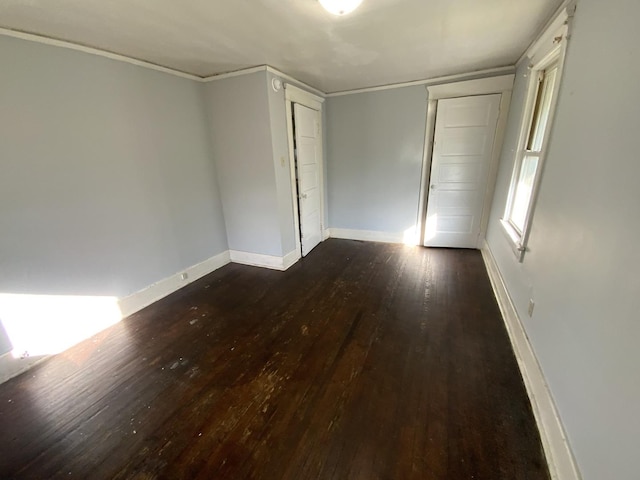 405 Chandler St, Danville, IL 61832 - unfurnished bedroom featuring dark wood-style flooring, crown molding, and baseboards