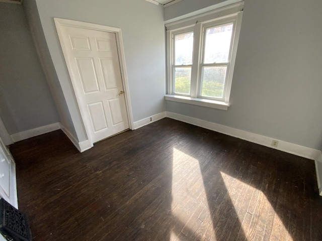 405 Chandler St, Danville, IL 61832 - unfurnished bedroom with baseboards and dark wood finished floors
