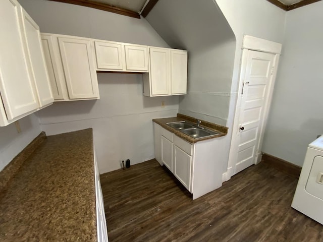 405 Chandler St, Danville, IL 61832 - kitchen with dark wood-style flooring, white cabinets, a sink, vaulted ceiling, and washer / dryer