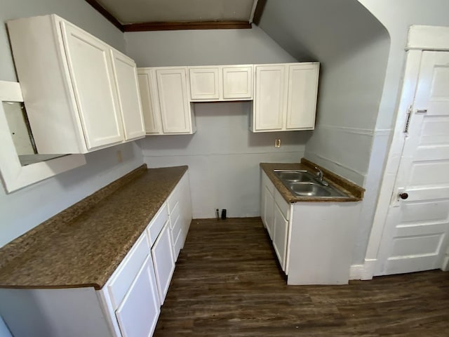 405 Chandler St, Danville, IL 61832 - kitchen featuring dark wood-type flooring, white cabinetry, a sink, and dark countertops