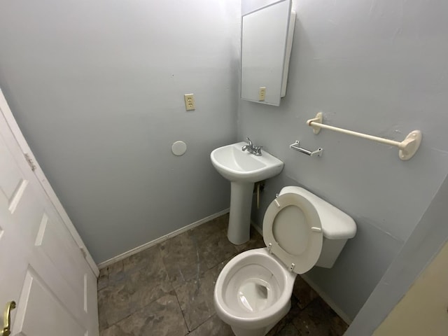 405 Chandler St, Danville, IL 61832 - bathroom featuring baseboards, toilet, and a sink