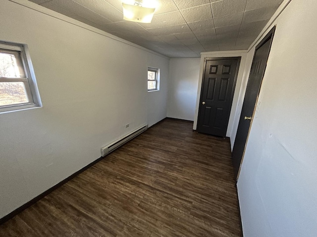409 Chandler St, Danville, IL 61832 - spare room with dark wood-style floors, baseboards, and a baseboard heating unit