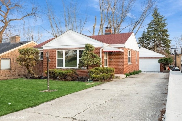 270 W 10th St, Chicago Heights, IL 60411 - view of front of house with a chimney, a detached garage, a front yard, brick siding, and an outbuilding