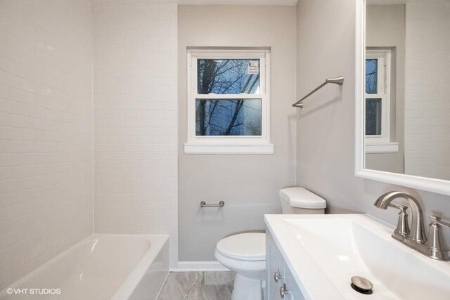 270 W 10th St, Chicago Heights, IL 60411 - bathroom featuring washtub / shower combination, baseboards, marble finish floor, toilet, and vanity