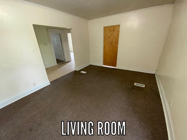 716 Robinson St, Danville, IL 61832 - unfurnished room featuring baseboards, visible vents, and dark colored carpet