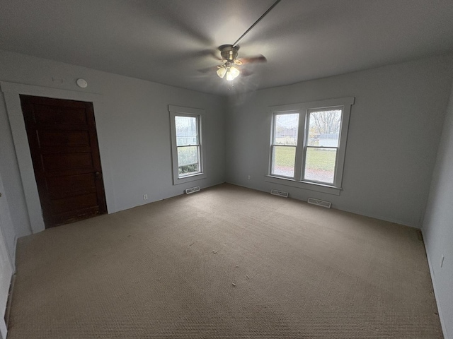 716 Robinson St, Danville, IL 61832 - spare room with ceiling fan, visible vents, and a healthy amount of sunlight