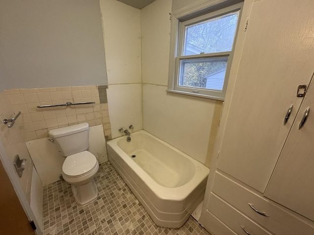 716 Robinson St, Danville, IL 61832 - full bathroom with a bathing tub, toilet, tile walls, and tile patterned floors