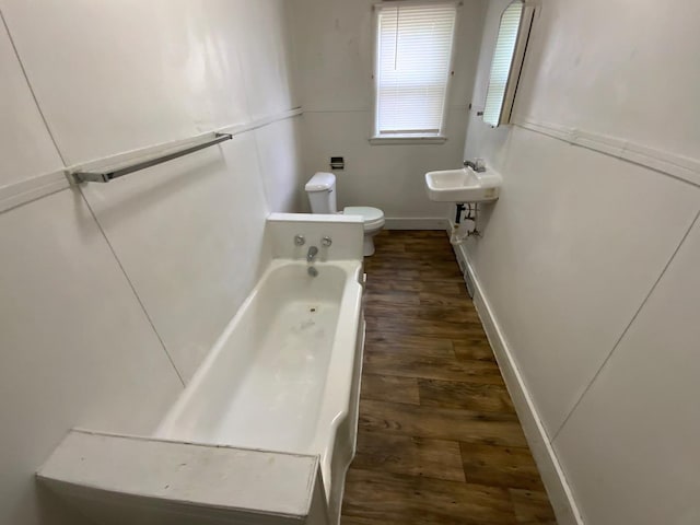 716 Robinson St, Danville, IL 61832 - bathroom with wood finished floors, toilet, baseboards, a sink, and a bath