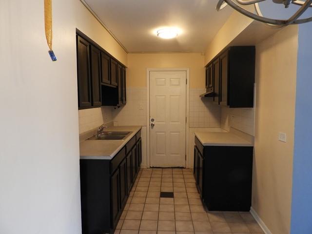 13715 S Stewart Ave Unit 2E, Riverdale, IL 60827 - kitchen featuring a sink, light countertops, light tile patterned floors, and tasteful backsplash