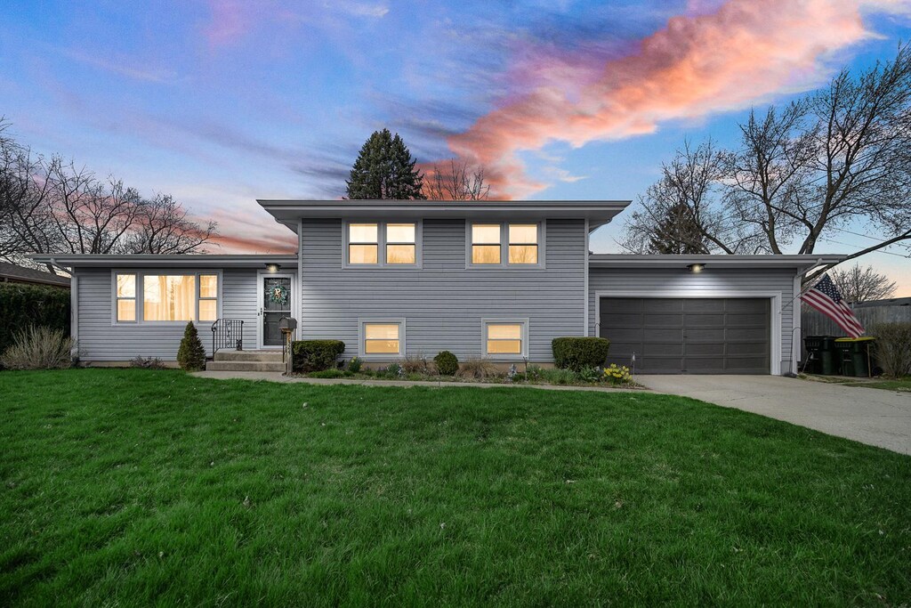 324 Weber Ct, Cary, IL 60013 - tri-level home with a lawn, driveway, and a garage