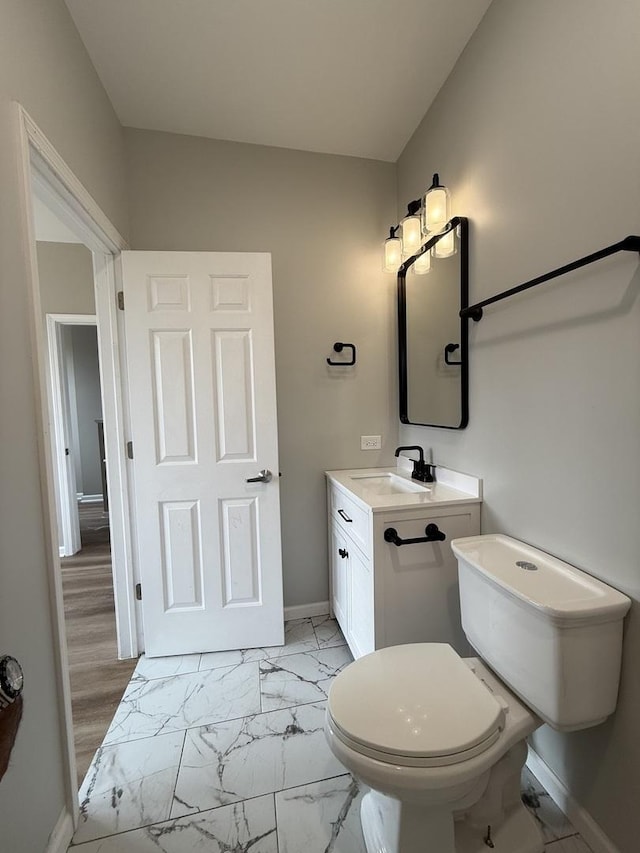 1333 N Burling St Unit B, Chicago, IL 60610 - bathroom featuring vanity, baseboards, marble finish floors, and toilet
