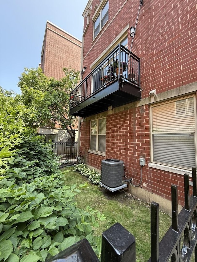 1333 N Burling St Unit B, Chicago, IL 60610 - view of side of home with a balcony, central AC unit, and brick siding