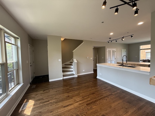 1333 N Burling St Unit B, Chicago, IL 60610 - kitchen with rail lighting, dark wood-style flooring, healthy amount of natural light, and light countertops