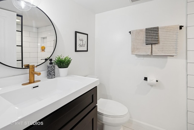 3762 N Odell Ave, Chicago, IL 60634 - bathroom with toilet, baseboards, and vanity