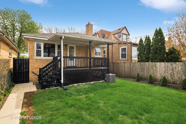 3762 N Odell Ave, Chicago, IL 60634 - back of house featuring a lawn, a fenced backyard, central air condition unit, and brick siding