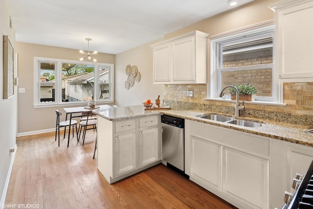 3762 N Odell Ave, Chicago, IL 60634 - kitchen with tasteful backsplash, dishwasher, a sink, white cabinets, and light wood-style floors