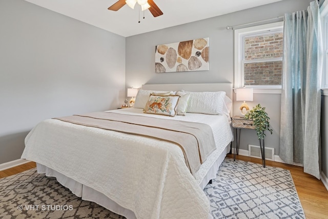 3762 N Odell Ave, Chicago, IL 60634 - bedroom featuring visible vents, baseboards, ceiling fan, and wood finished floors