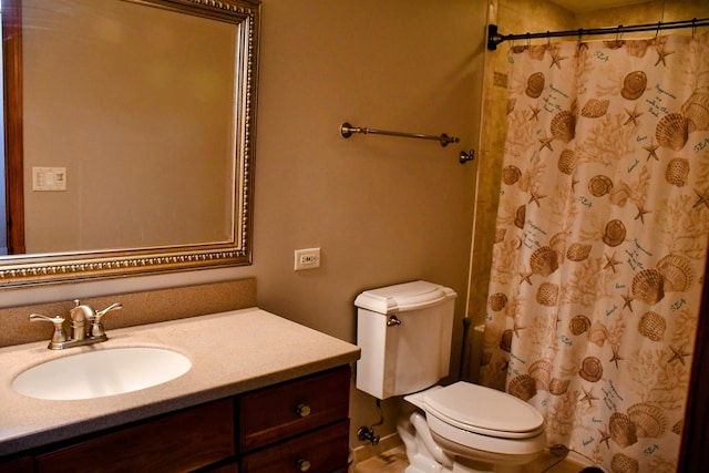 bathroom featuring curtained shower, toilet, and vanity