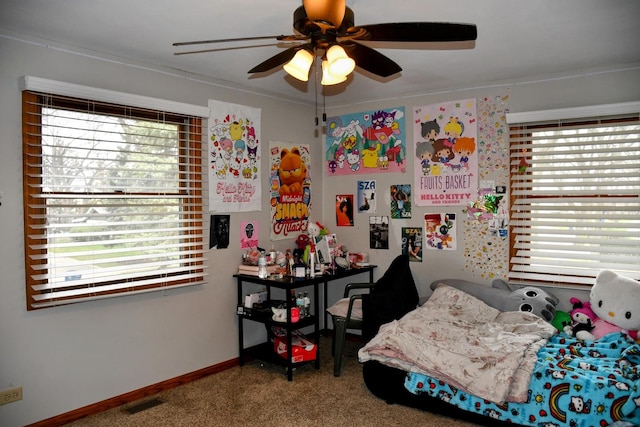 bedroom with carpet floors, ceiling fan, and multiple windows
