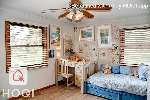 bedroom featuring ceiling fan, multiple windows, and light wood-style floors