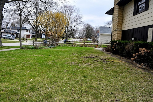 view of yard featuring a residential view and fence
