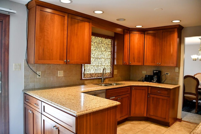 kitchen with recessed lighting, light stone counters, light tile patterned floors, a sink, and tasteful backsplash
