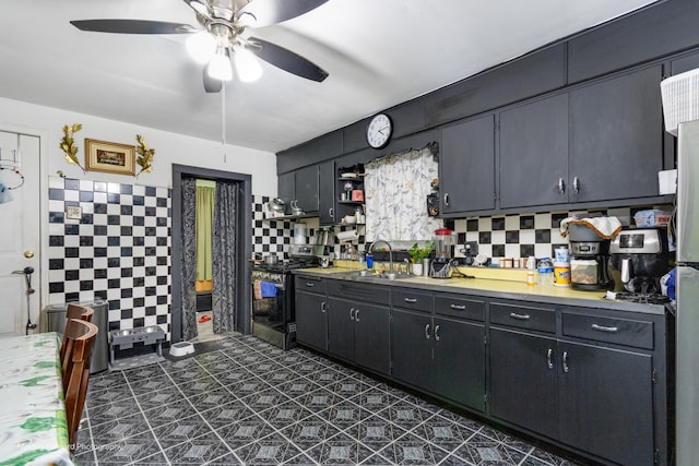 3041 S Drake Ave, Chicago, IL 60623 - kitchen featuring light countertops, open shelves, stainless steel gas stove, a sink, and a ceiling fan