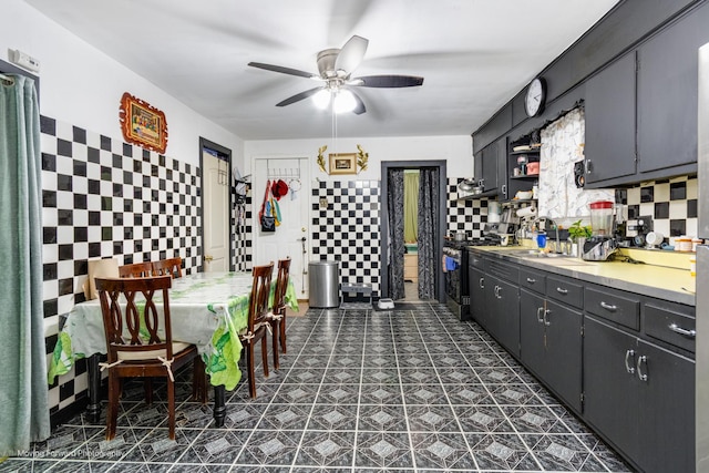 3041 S Drake Ave, Chicago, IL 60623 - kitchen with a sink, open shelves, stainless steel gas range oven, ceiling fan, and tile walls