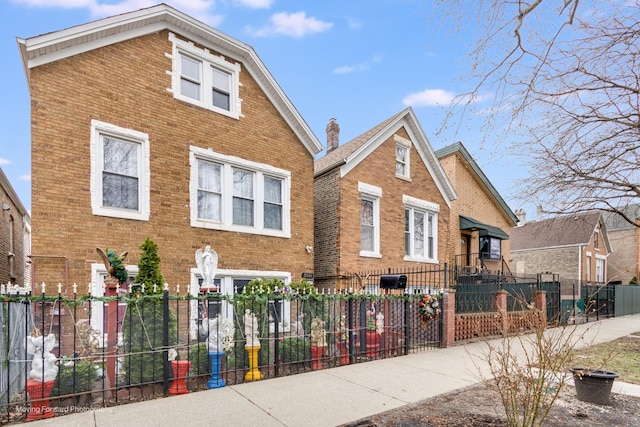 3041 S Drake Ave, Chicago, IL 60623 - view of front facade with a chimney, a fenced front yard, and brick siding