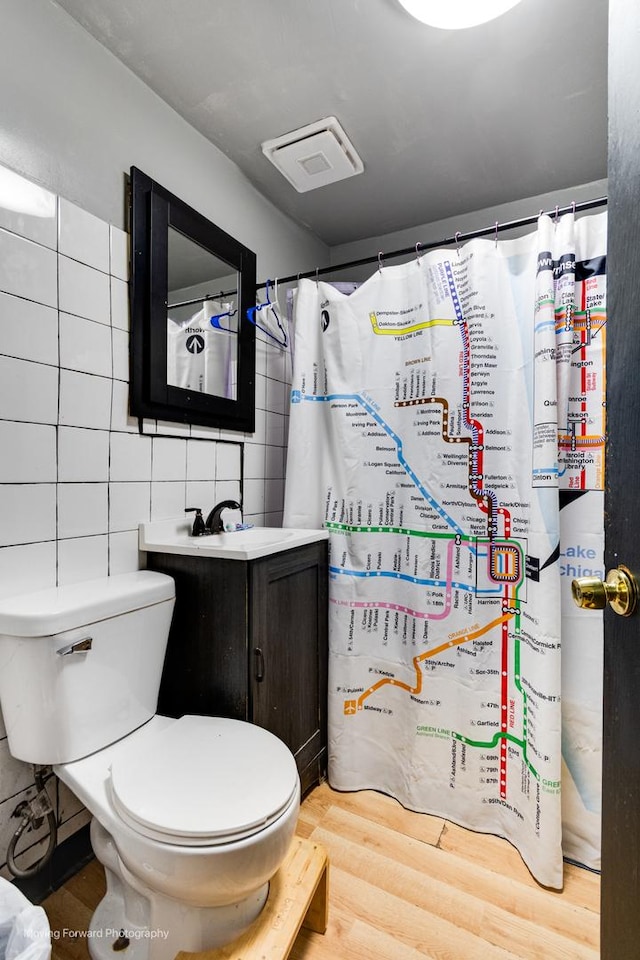 3041 S Drake Ave, Chicago, IL 60623 - full bathroom with tile walls, visible vents, toilet, and wood finished floors