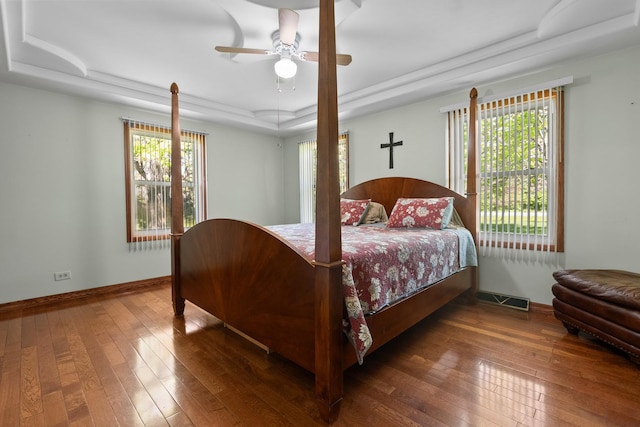 3315 E Bemes Rd, Crete, IL 60417 - bedroom with a raised ceiling, wood-type flooring, multiple windows, and a ceiling fan