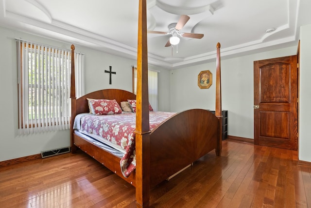 3315 E Bemes Rd, Crete, IL 60417 - bedroom with a tray ceiling, wood-type flooring, multiple windows, and baseboards