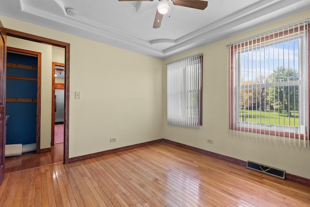 3315 E Bemes Rd, Crete, IL 60417 - unfurnished room featuring a tray ceiling, light wood-type flooring, ceiling fan, and baseboards