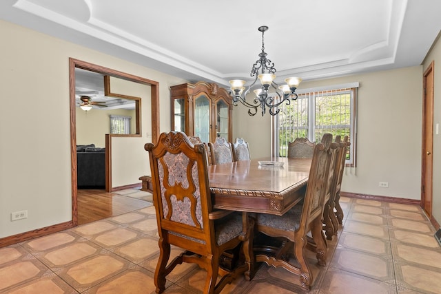 3315 E Bemes Rd, Crete, IL 60417 - dining room with a tray ceiling, a chandelier, baseboards, and light tile patterned floors