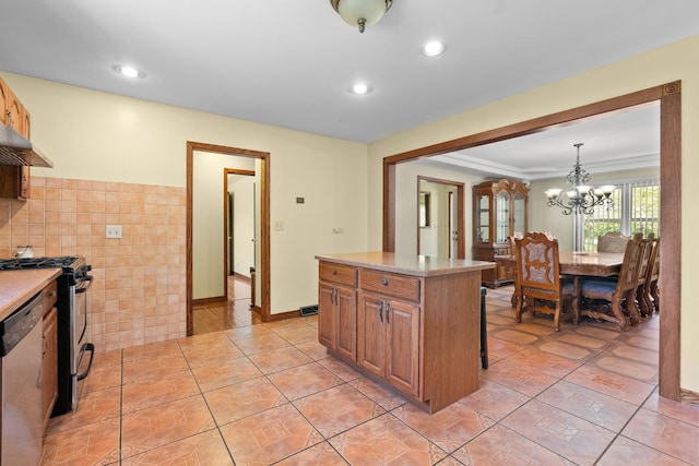 3315 E Bemes Rd, Crete, IL 60417 - kitchen featuring stainless steel appliances, under cabinet range hood, tile walls, light countertops, and a kitchen island