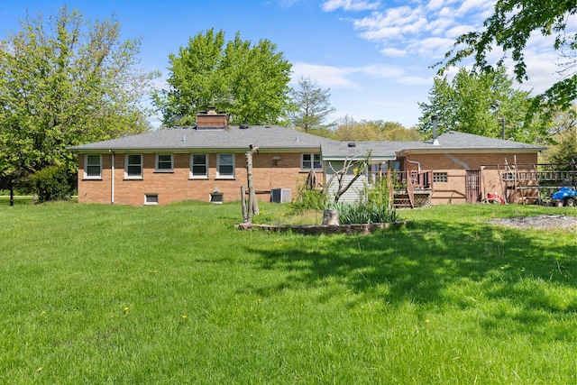 3315 E Bemes Rd, Crete, IL 60417 - rear view of house with cooling unit, a chimney, a lawn, and brick siding