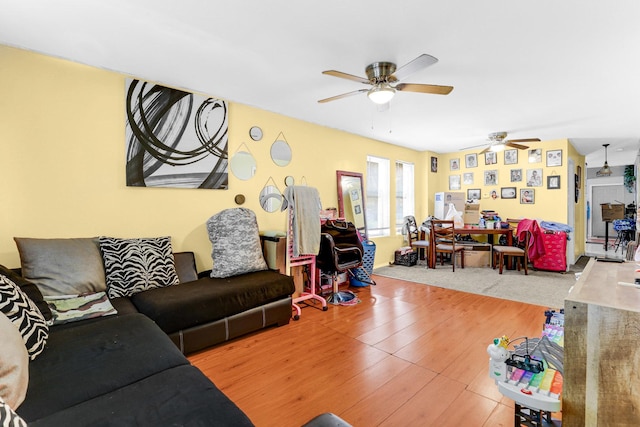 living area with wood finished floors and ceiling fan