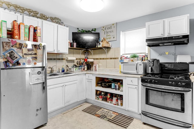 kitchen with a sink, open shelves, under cabinet range hood, stainless steel appliances, and white cabinets
