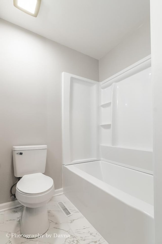 bathroom featuring marble finish floor, baseboards, visible vents, and toilet