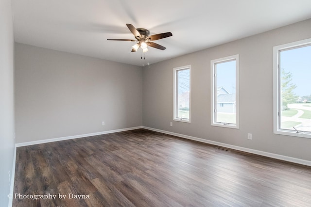 unfurnished room with a ceiling fan, plenty of natural light, baseboards, and visible vents