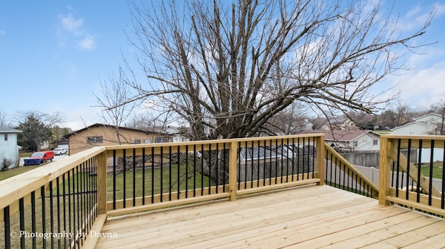 wooden deck featuring a yard