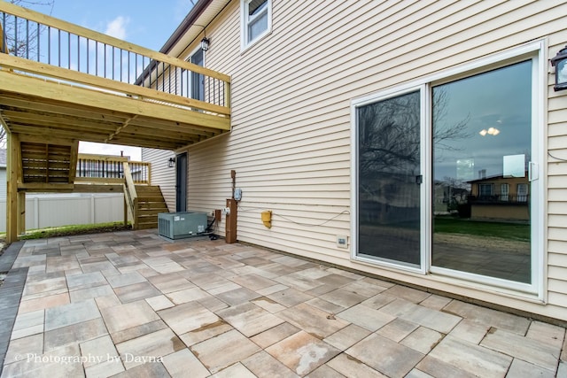 view of patio / terrace with cooling unit, stairs, and a wooden deck